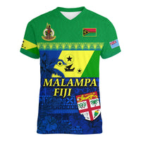 Green V-neck t-shirt with blue-yellow island design, crest and flag patches, front text