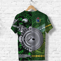 Green T-shirt with Aotearoa banner, large white circular emblem, tribal pattern artwork