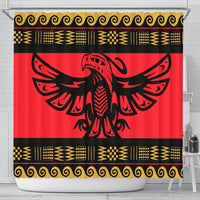 Red shower curtain with bold black bird emblem and gold tribal borders