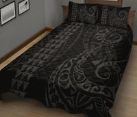 Grey quilt bed set with triangle geo pattern and Polynesian-style swirls; 2 pillows