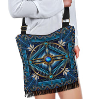 Blue boho crossbody handbag with starburst beading and fringe hem, worn with black strap
