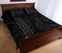 Grey quilt bed set with flowing swirl accents and geometric triangles; two pillows