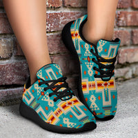 Turquoise tribal sport sneakers, black laces and sole, worn ankle-high view