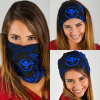 Blue tribal wave bandana with black geometric swirls and sun emblem, worn over face