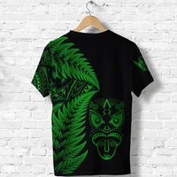 Black T-shirt with green fern and tiki face graphic on the back