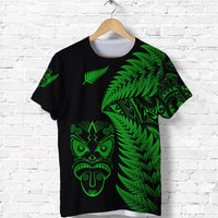 Black T-shirt with green fern and tiki face graphic on the front