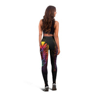 Black leggings featuring butterfly and abstract Polynesian patterns, full back view