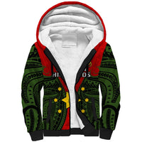 Sherpa hoodie with red hood, green tribal pattern, and black contrast panels
