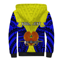 Yellow sherpa hoodie with blue tribal back print, black cuffs, orange bird emblem