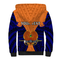 Orange sherpa hoodie back with navy tribal print, gold emblem, 'YOUR TEXT' graphic, hood.