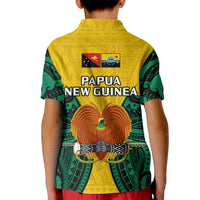 Kids yellow polo shirt with green patterned sleeves and Papua New Guinea back print