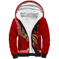 Red sherpa hoodie with white-lined hood and black zipper front, detailed sleeve print