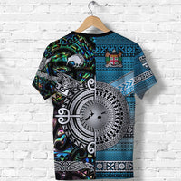 Blue and black graphic T-shirt back with large circular tribal emblem and tiki-style patterns