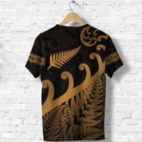 Black T-shirt with gold Maori fern and koru patterns, back view