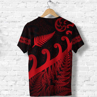 Dark rugby T-shirt with red Maori print and fern frond motif on back