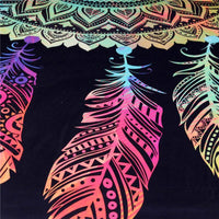 Close view of multicolor dreamcatcher feathers and scalloped trim on dark fabric