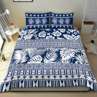Navy and white bedding set with tropical leaves, floral motifs, and patterned borders