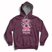 Women’s maroon hoodie with front kangaroo pocket, drawstring hood, and pink Women’s Day graphic