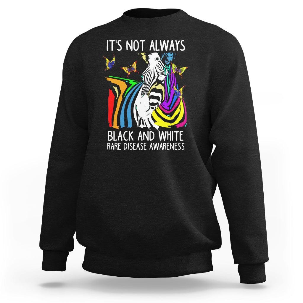 Kids black crewneck sweatshirt with zebra and rainbow awareness graphic on front.