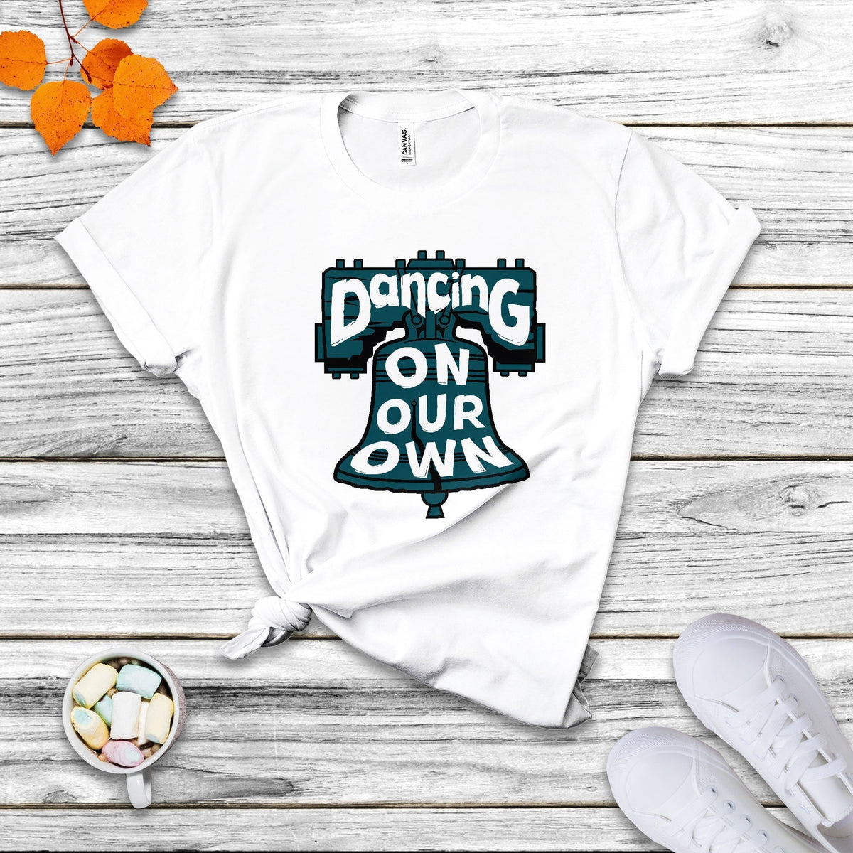 White crew-neck T-shirt with colorful "Dancing On Our Own" graphic front.