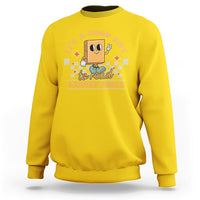 Daisy yellow sweatshirt with "Banned Books" graphic and reading character print
