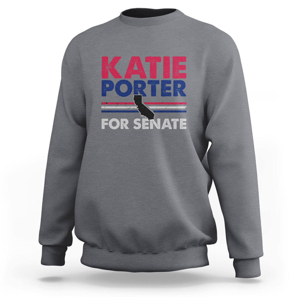 Light heather gray crewneck sweatshirt with front graphic text: KATIE PORTER FOR SENATE