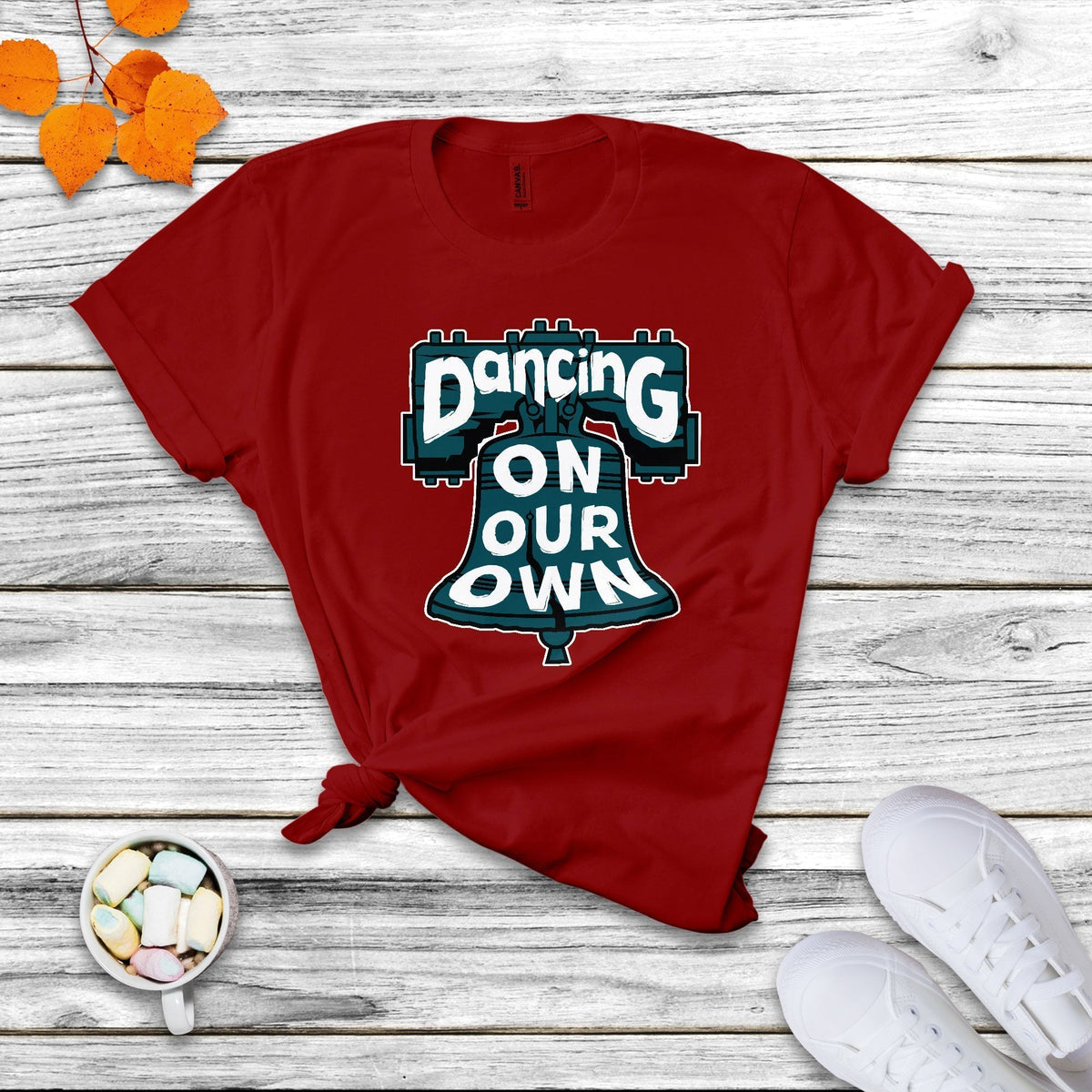 Red crew-neck T-shirt with colorful "Dancing On Our Own" graphic front.