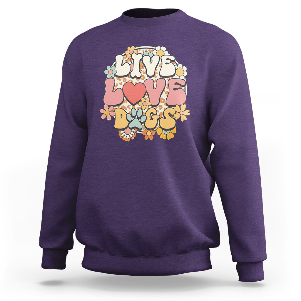 Purple sweatshirt with “LIVE LOVE DOGS” graphic and colorful paw and flower design