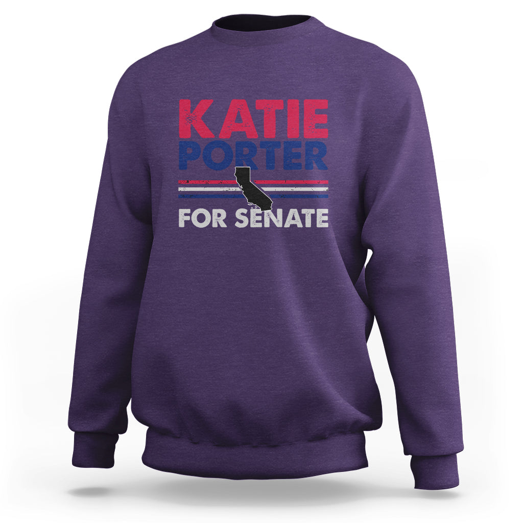 Purple crewneck sweatshirt with front graphic text: KATIE PORTER FOR SENATE