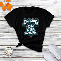 Black crew-neck T-shirt with colorful "Dancing On Our Own" graphic front.