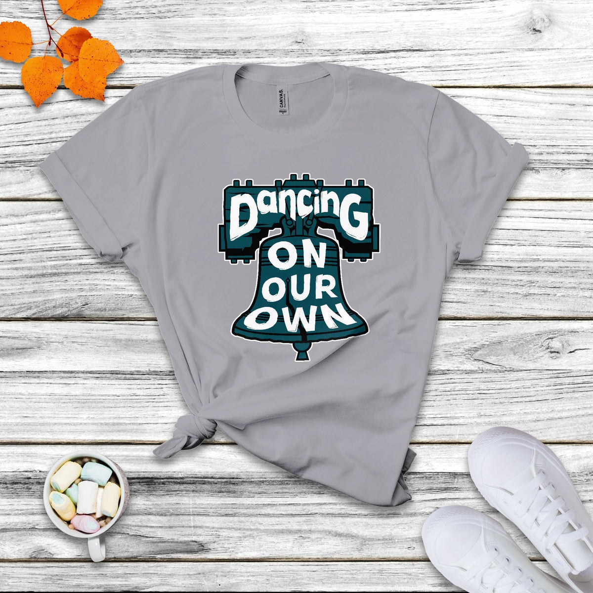 Light gray crew-neck T-shirt with colorful "Dancing On Our Own" graphic front.
