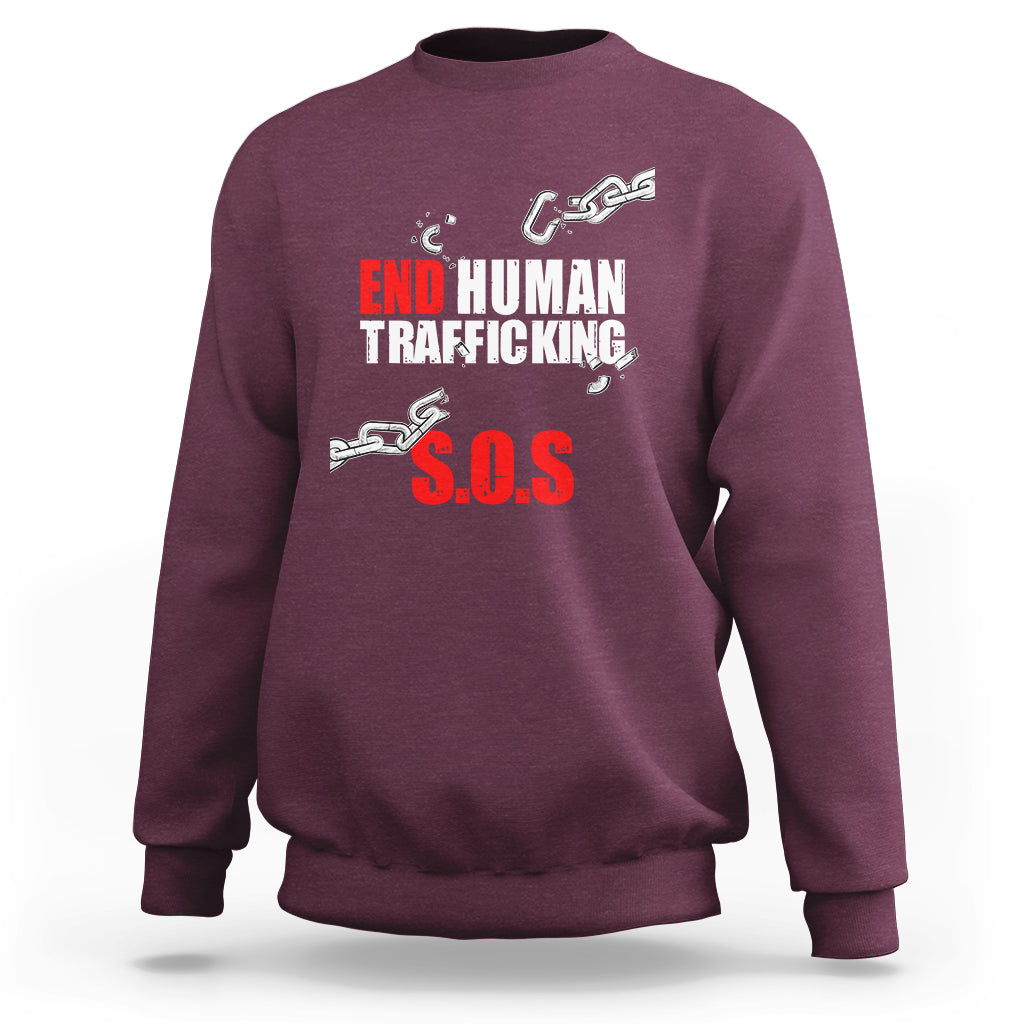 Maroon crewneck sweatshirt with 'END HUMAN TRAFFICKING' and red 'S.O.S.' graphic