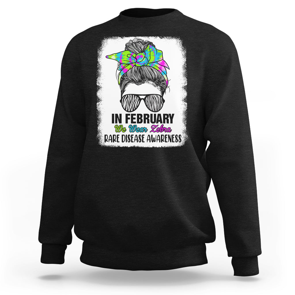 Black crewneck sweatshirt with zebra messy-bun graphic and 'Rare Disease Awareness'
