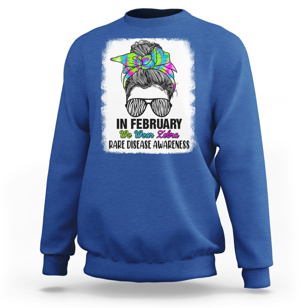 Royal blue crewneck sweatshirt with zebra messy-bun graphic and 'Rare Disease Awareness'