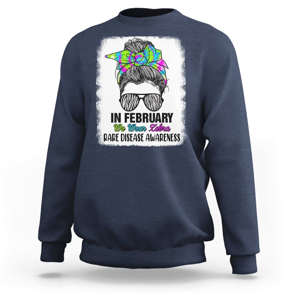 Navy crewneck sweatshirt with zebra messy-bun graphic and 'Rare Disease Awareness'