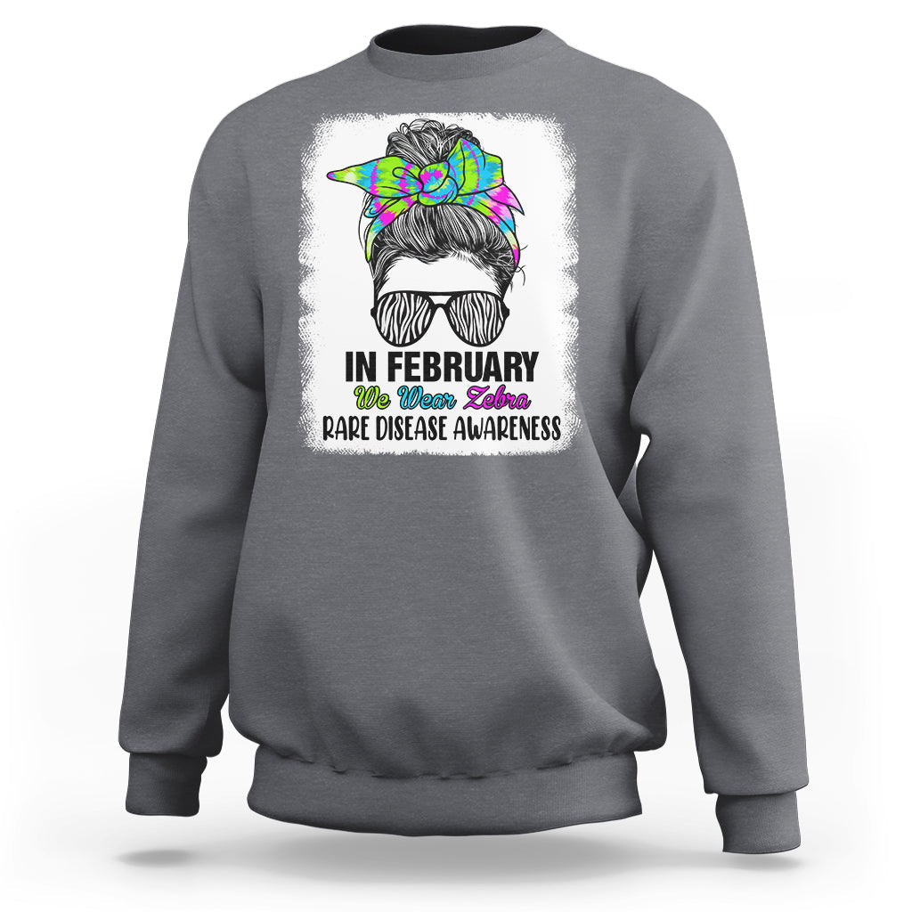 Charcoal crewneck sweatshirt with zebra messy-bun graphic and 'Rare Disease Awareness'