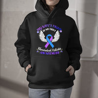 Black pullover hoodie with purple ribbon and white wings graphic on chest
