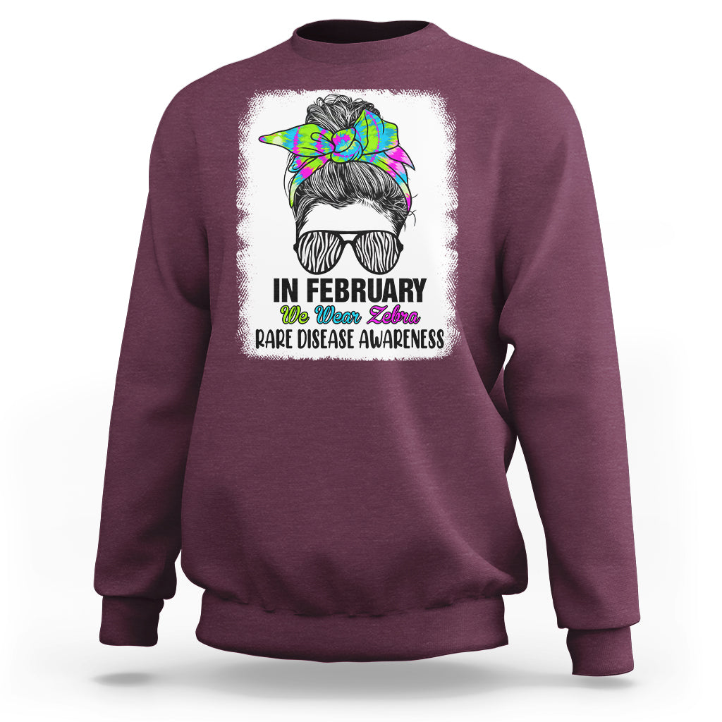 Maroon crewneck sweatshirt with zebra messy-bun graphic and 'Rare Disease Awareness'