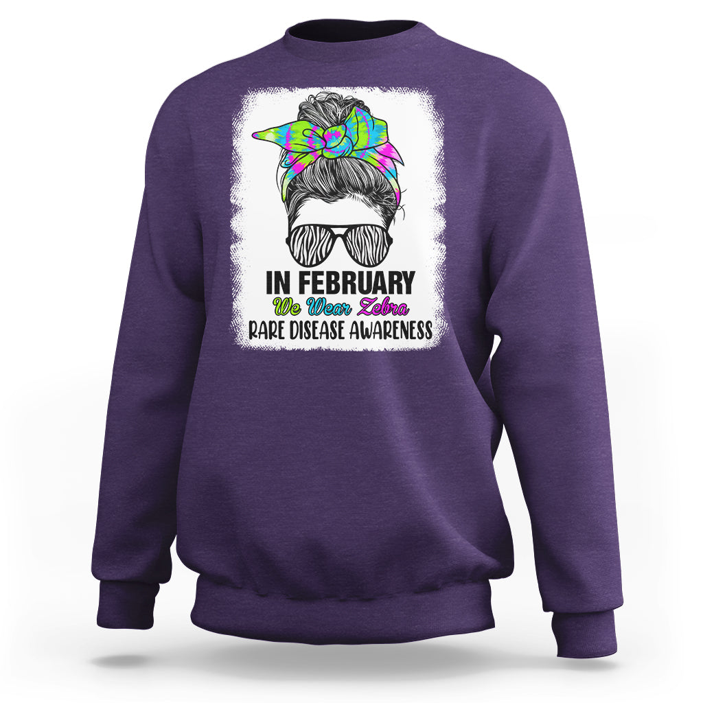 Purple crewneck sweatshirt with zebra messy-bun graphic and 'Rare Disease Awareness'