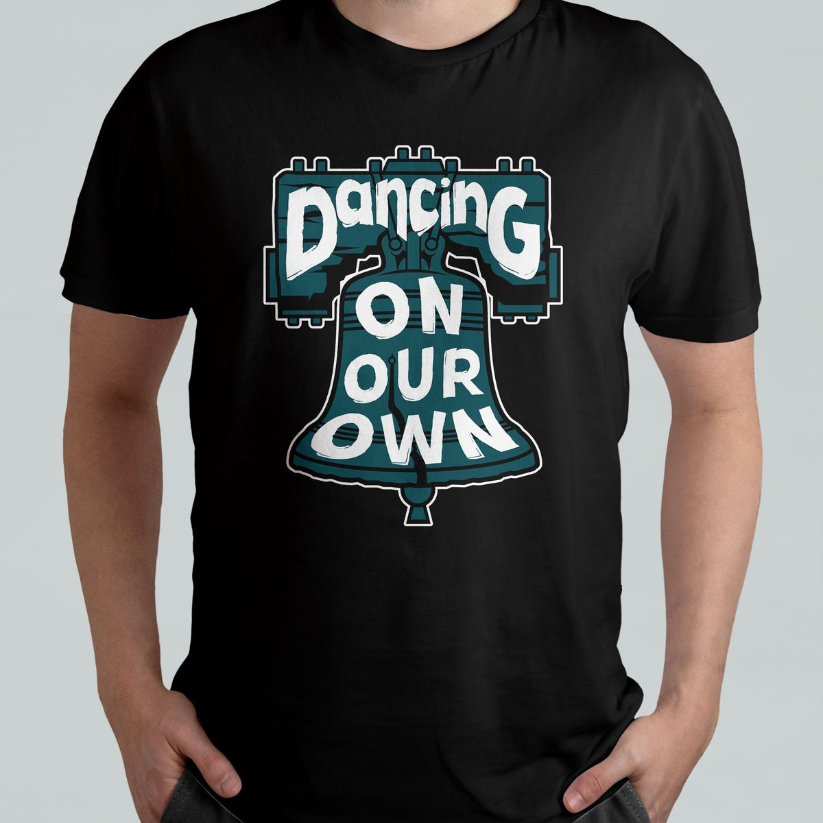 Black crew-neck T-shirt worn by model, featuring colorful "Dancing On Our Own" graphic.