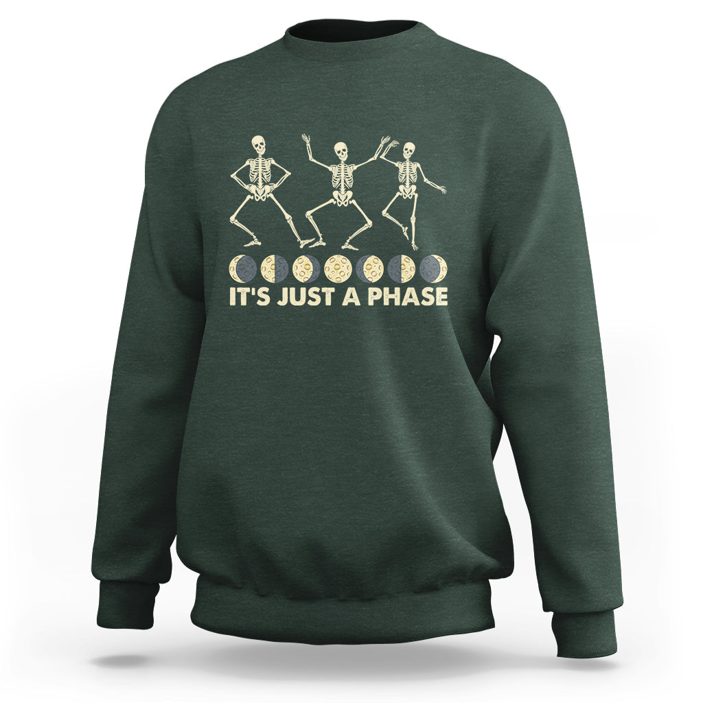 Forest green crewneck sweatshirt with dancing skeleton graphic and “IT’S JUST A PHASE” text