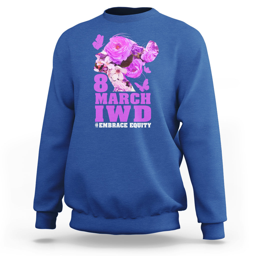 Royal blue women’s sweatshirt with floral IWD graphic and text #EMBRACE EQUITY on front