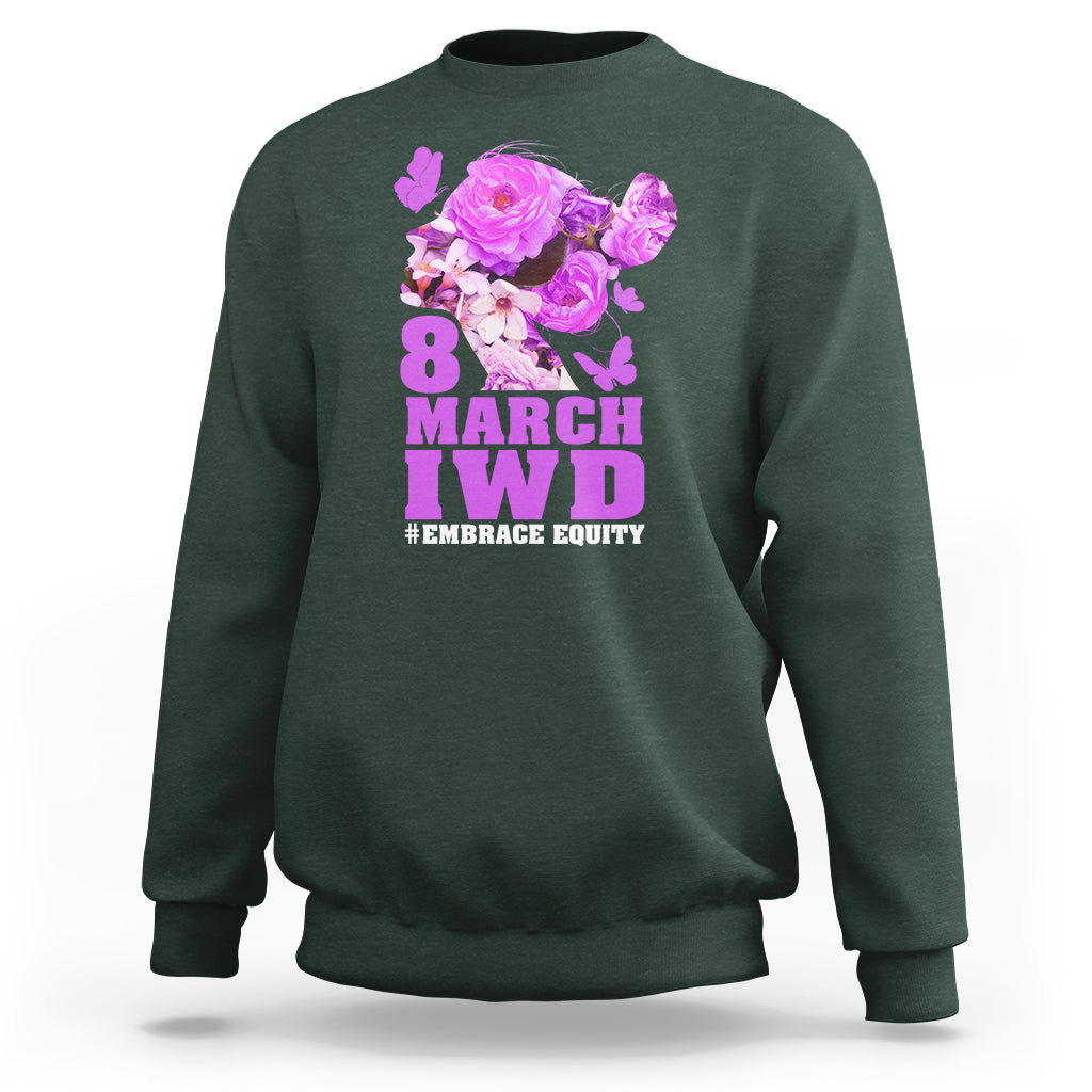 Forest green women’s sweatshirt with floral IWD graphic and text #EMBRACE EQUITY on front