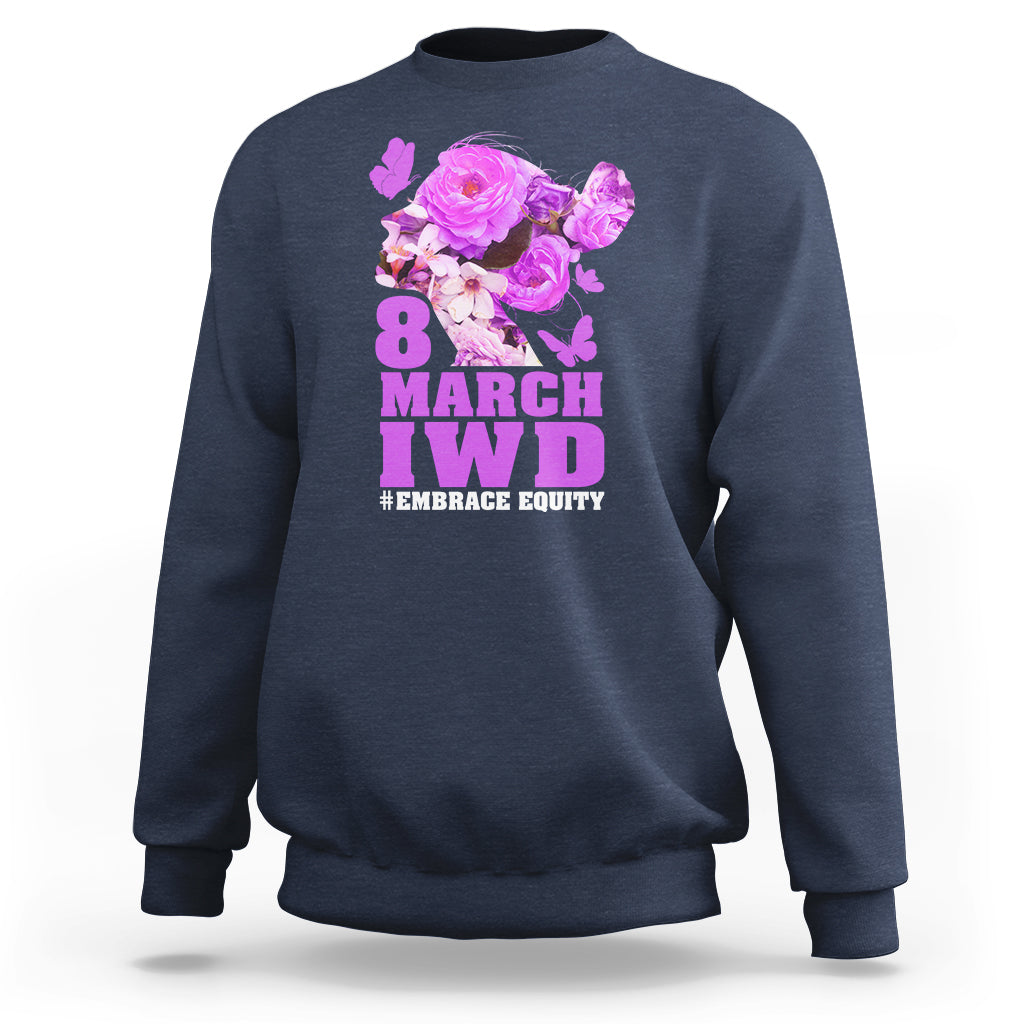 Navy women’s sweatshirt with floral IWD graphic and text #EMBRACE EQUITY on front