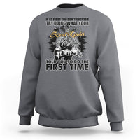 Charcoal crewneck sweatshirt with back graphic print and compass-style design.