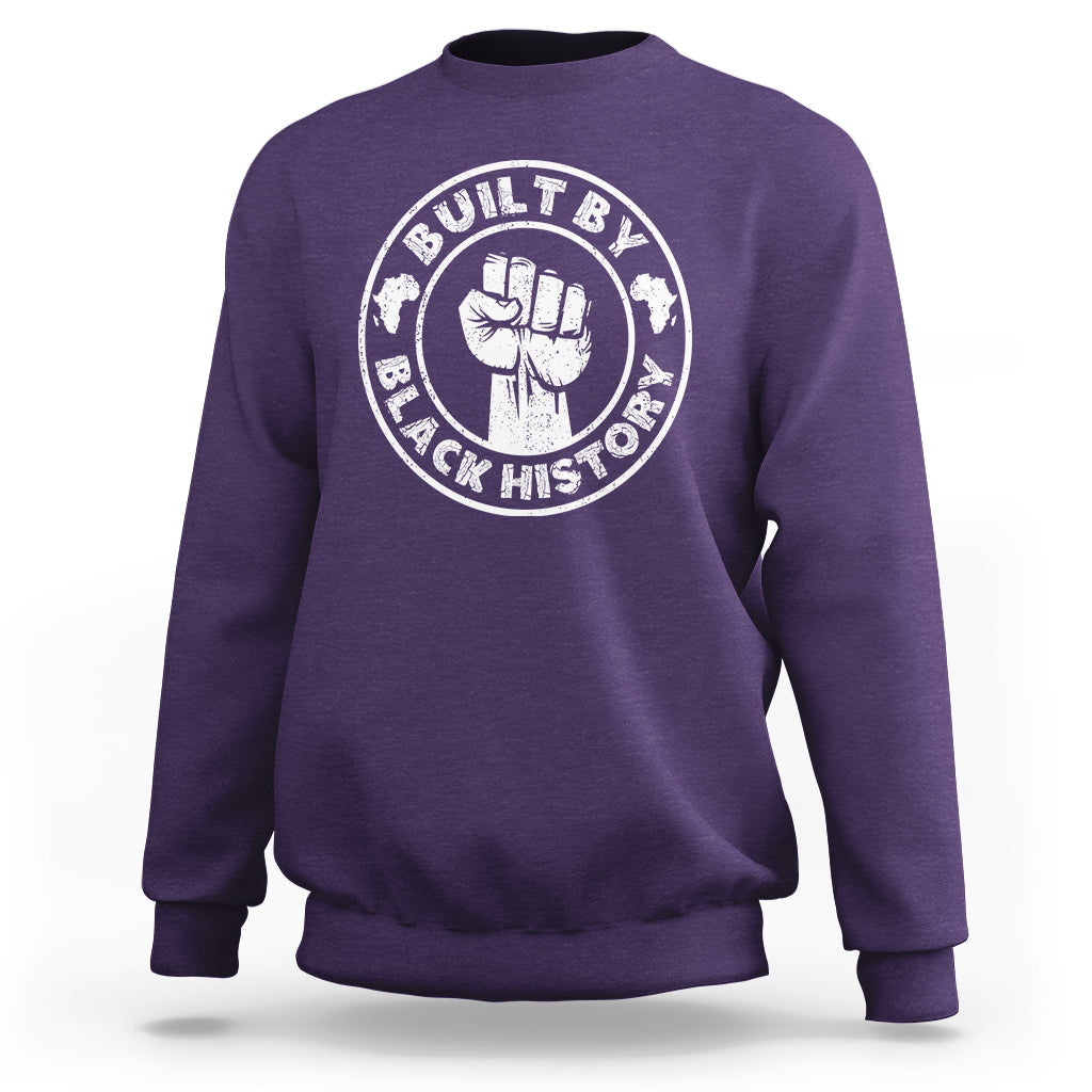 Purple crewneck sweatshirt with round “Built by Black History” graphic badge on chest