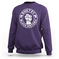 Purple crewneck sweatshirt with round “Built by Black History” graphic badge on chest