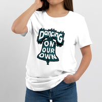 White crew-neck T-shirt worn by model, featuring colorful "Dancing On Our Own" graphic.