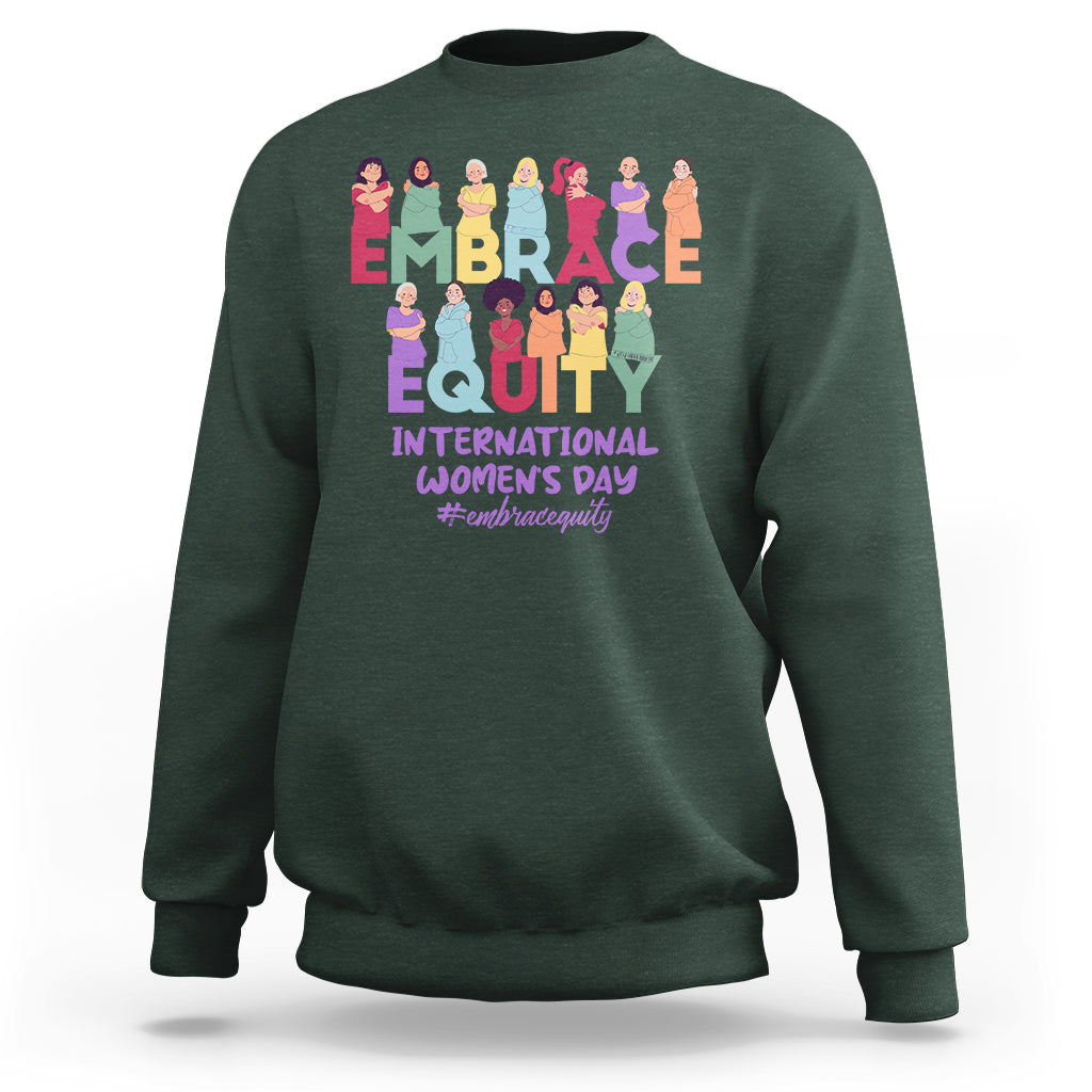 Forest green crewneck sweatshirt with colorful “EMBRACE EQUITY” women’s day graphic on back