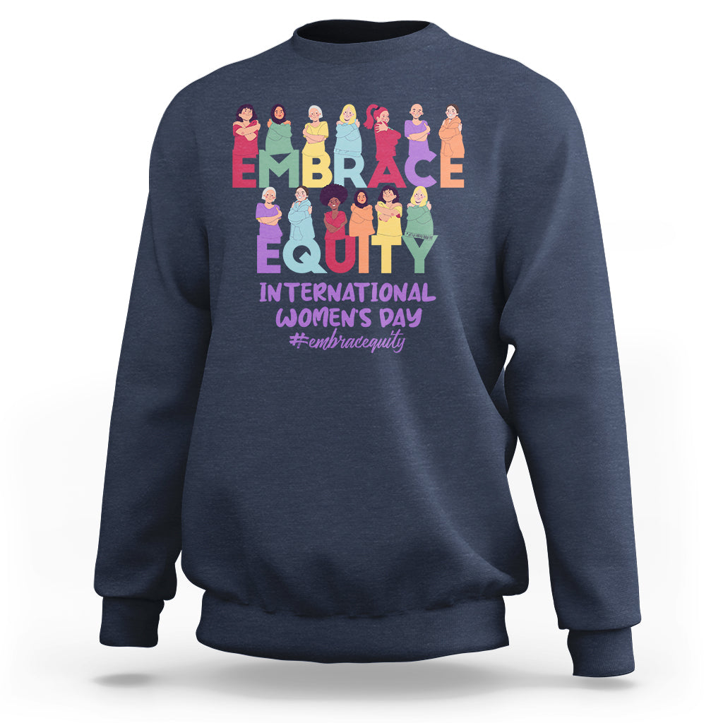 Navy crewneck sweatshirt with colorful “EMBRACE EQUITY” women’s day graphic on back